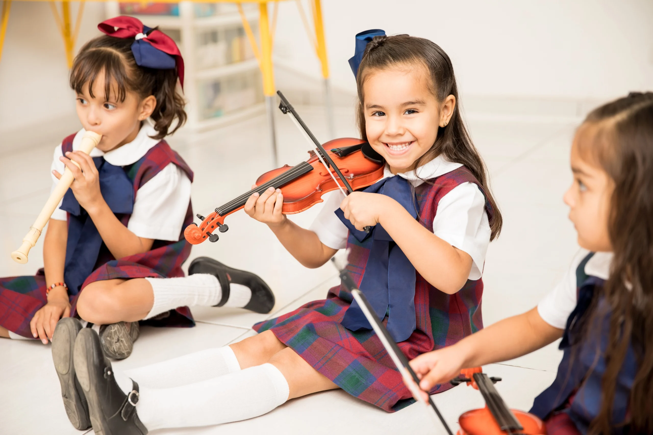 portrait-cute-latin-girl-learning-how-play-violin-having-fun-preschool